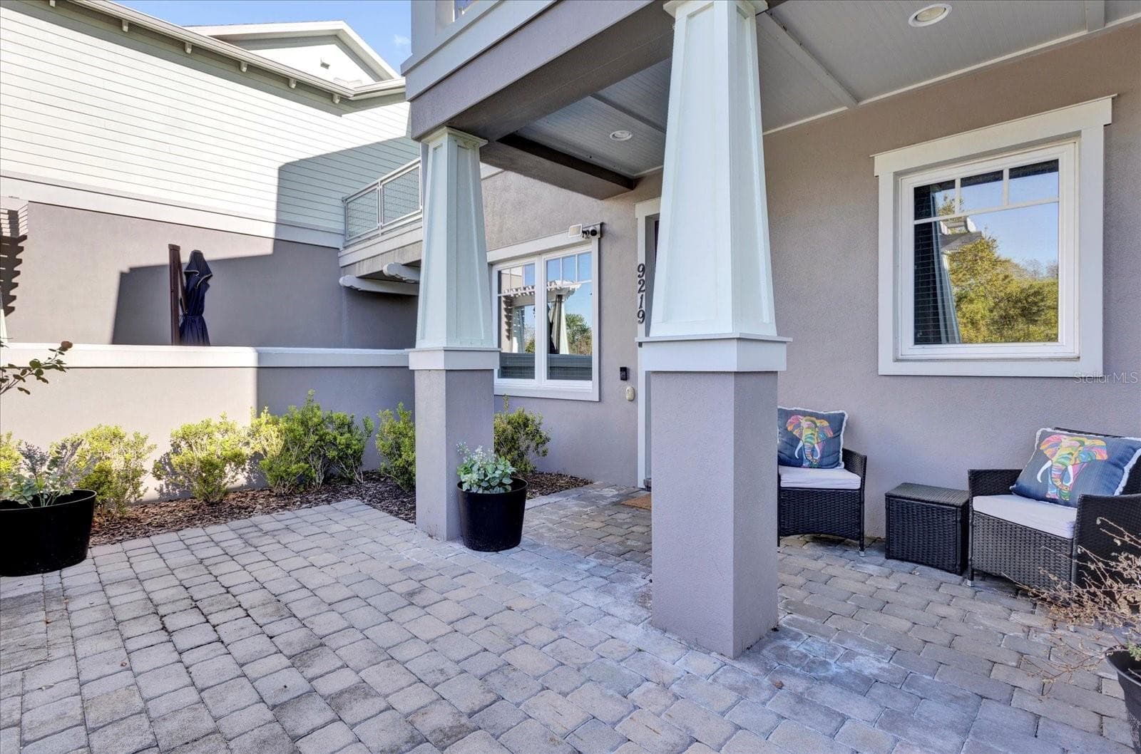 Private covered patio with paver flooring — the perfect low-maintenance outdoor retreat. - 9219 LAUREATE BLVD, ORLANDO