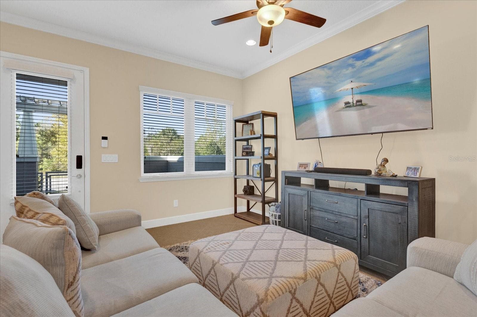 Cozy sitting area with ceiling fan and natural light, offering flexible living space. - 9219 LAUREATE BLVD, ORLANDO