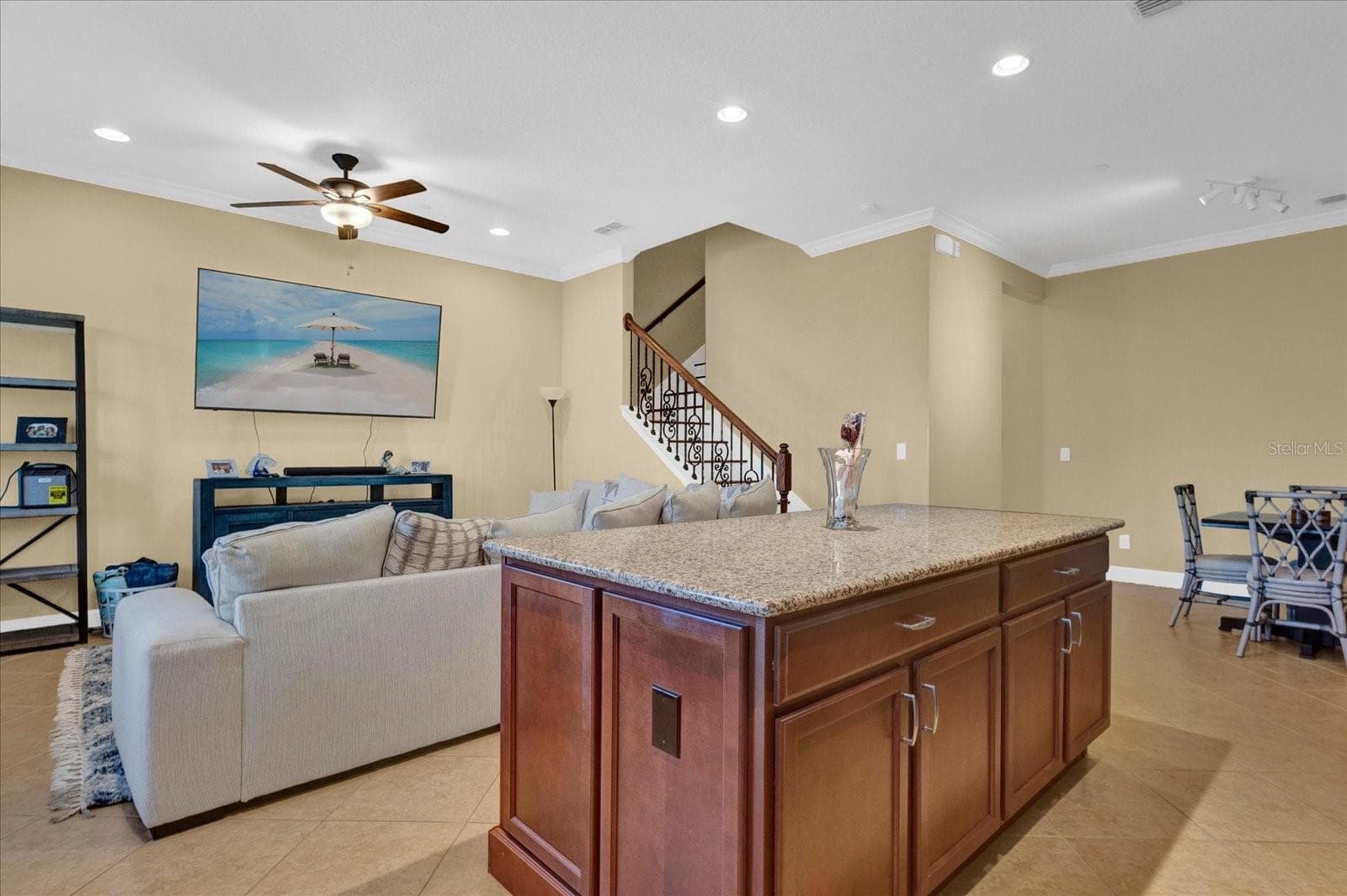 Open-concept living and kitchen area with a large center island — perfect for entertaining. - 9219 LAUREATE BLVD, ORLANDO