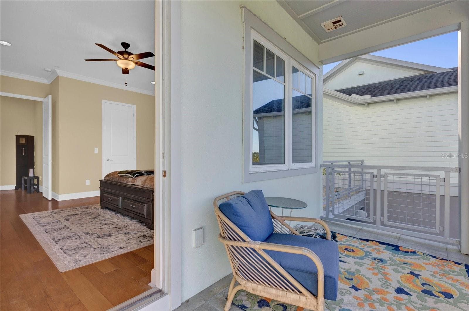 Private covered balcony off the primary suite — a peaceful spot to unwind. - 9219 LAUREATE BLVD, ORLANDO