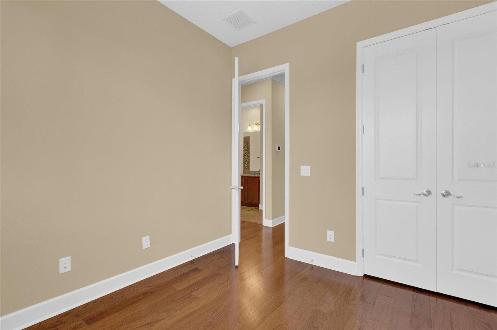 Additional view of bedroom 2, featuring ample closet space and easy access to the hall bath. - 9219 LAUREATE BLVD, ORLANDO