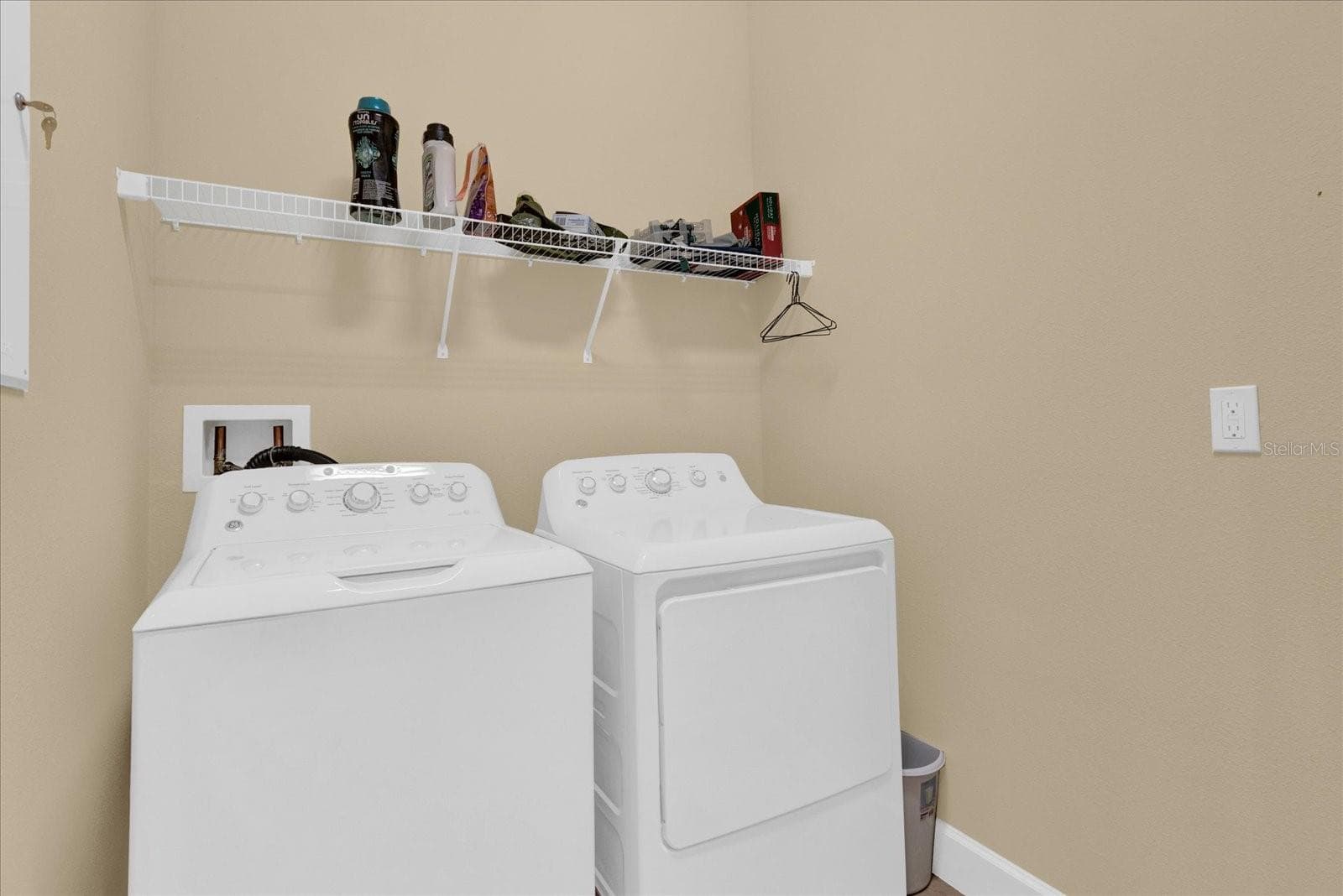 Convenient upstairs laundry room with built-in shelving. - 9219 LAUREATE BLVD, ORLANDO