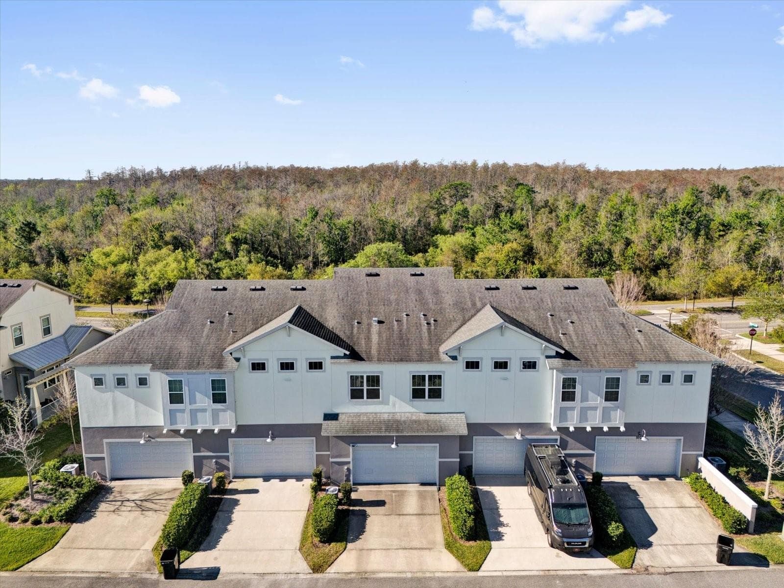 Aerial perspective showcasing the home's architecture and neighborhood setting. - 9219 LAUREATE BLVD, ORLANDO