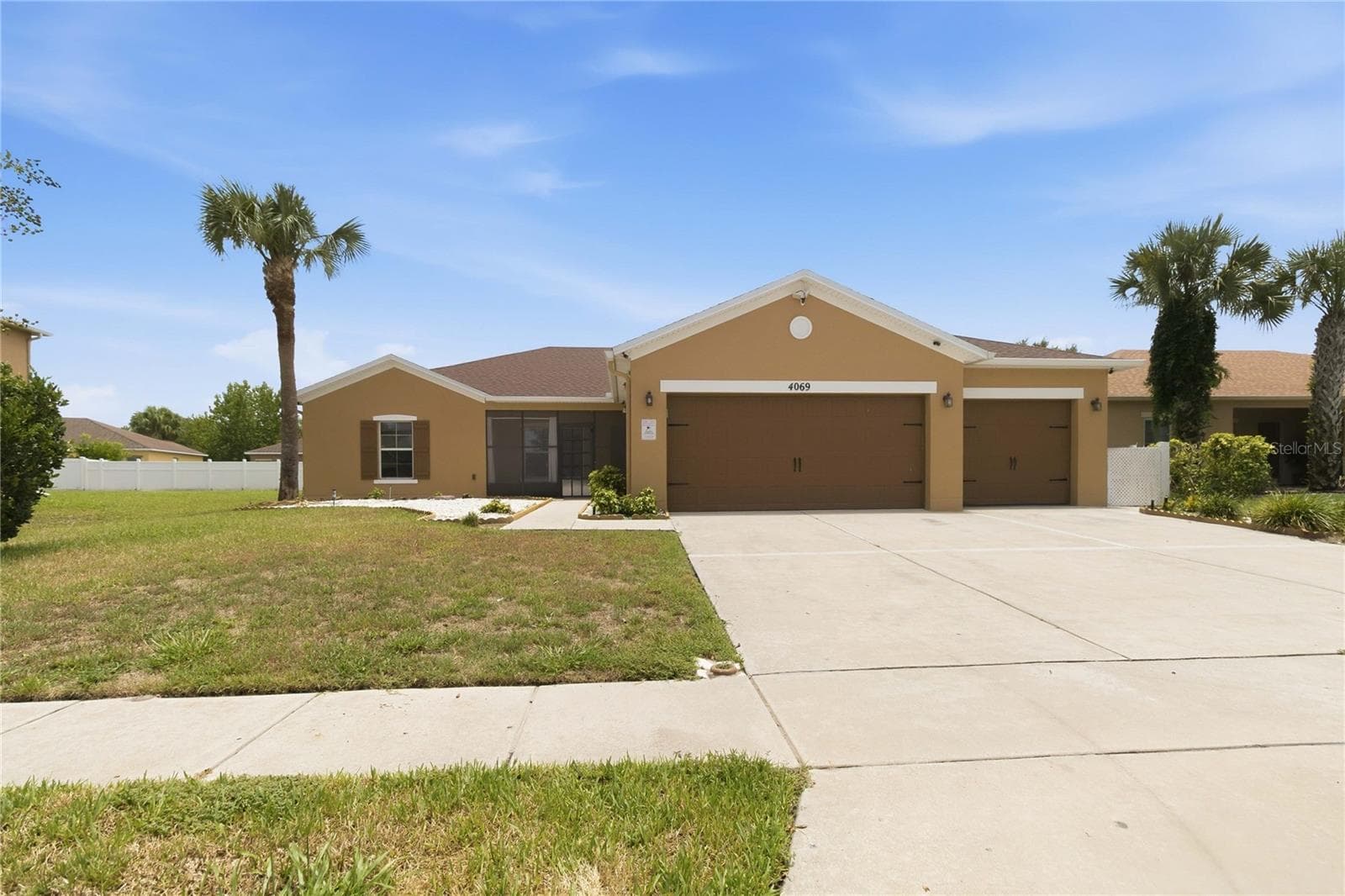 Exterior front, 3 car garage, fully fenced - 4069 MARINA ISLE DR, KISSIMMEE