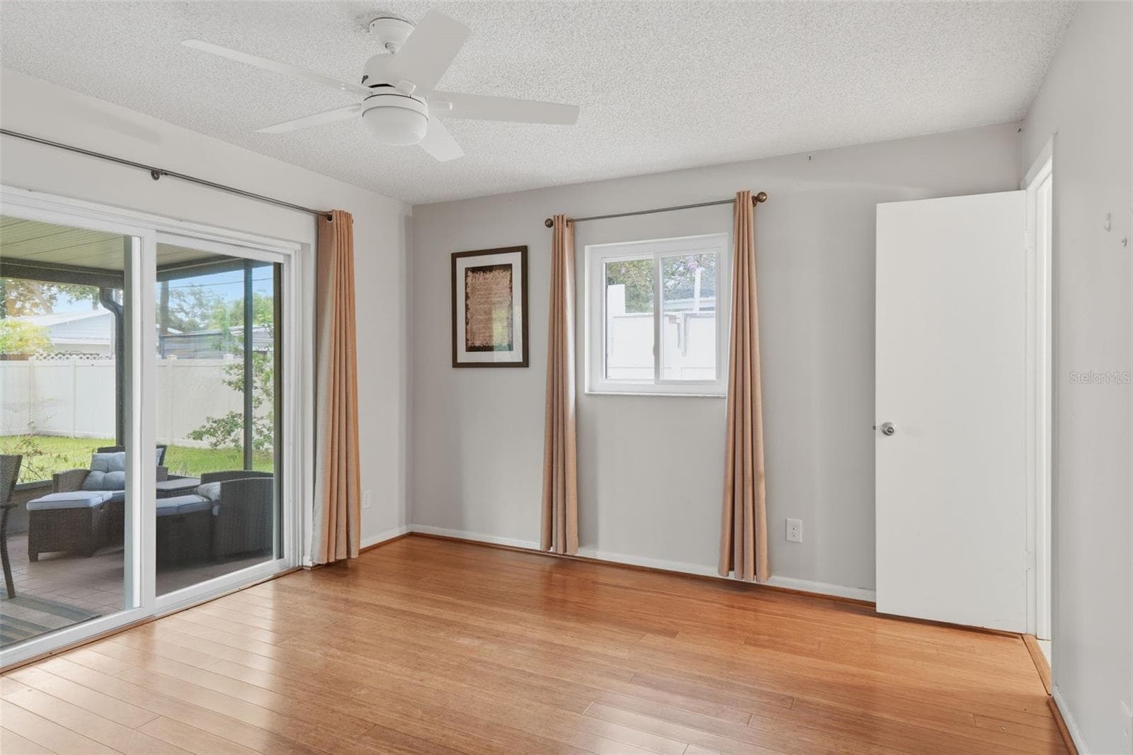 Primary Bedroom with entry to screened in back porch and yard - 205 SE MONROE CIR N, ST PETERSBURG