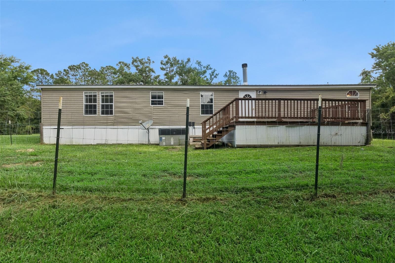 Rear view of house and fenced part of yard - 129 PATRICIAN PL, SATSUMA