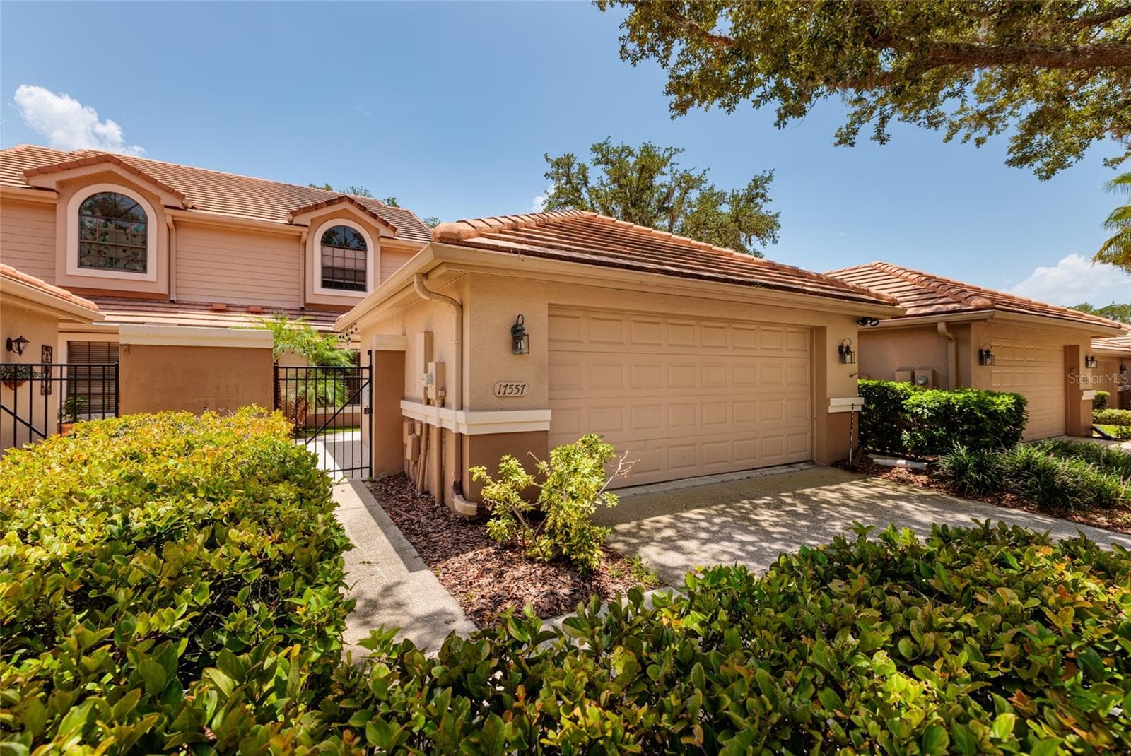 Front view with garage and entrance - 17557 FAIRMEADOW DR, TAMPA