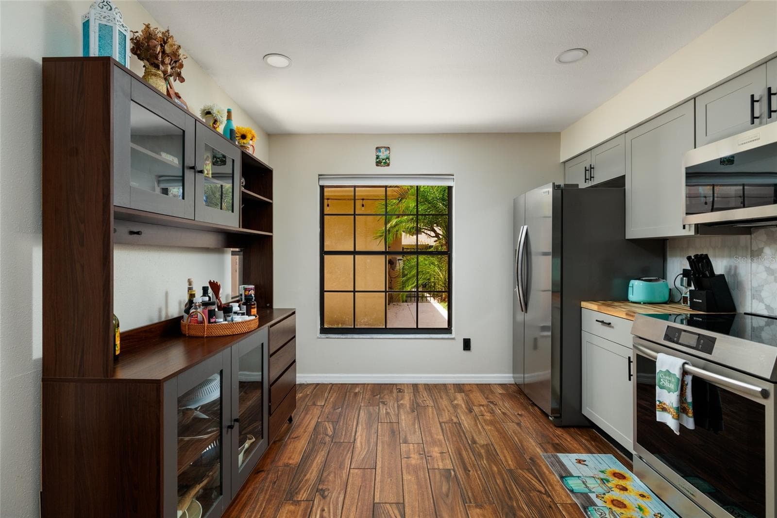kitchen and front window to patio view - 17557 FAIRMEADOW DR, TAMPA