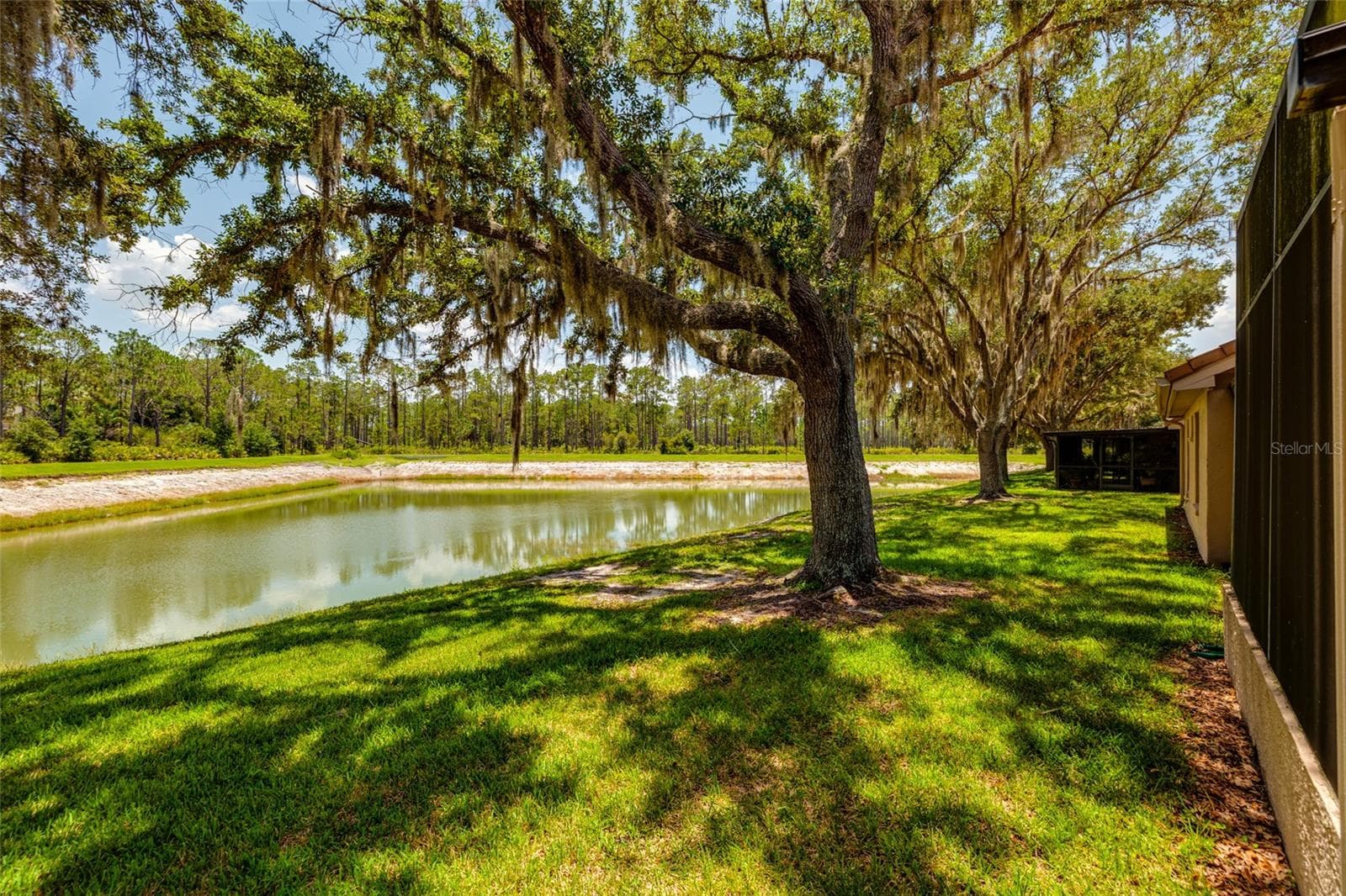 lake and yard view behind unit - 17557 FAIRMEADOW DR, TAMPA