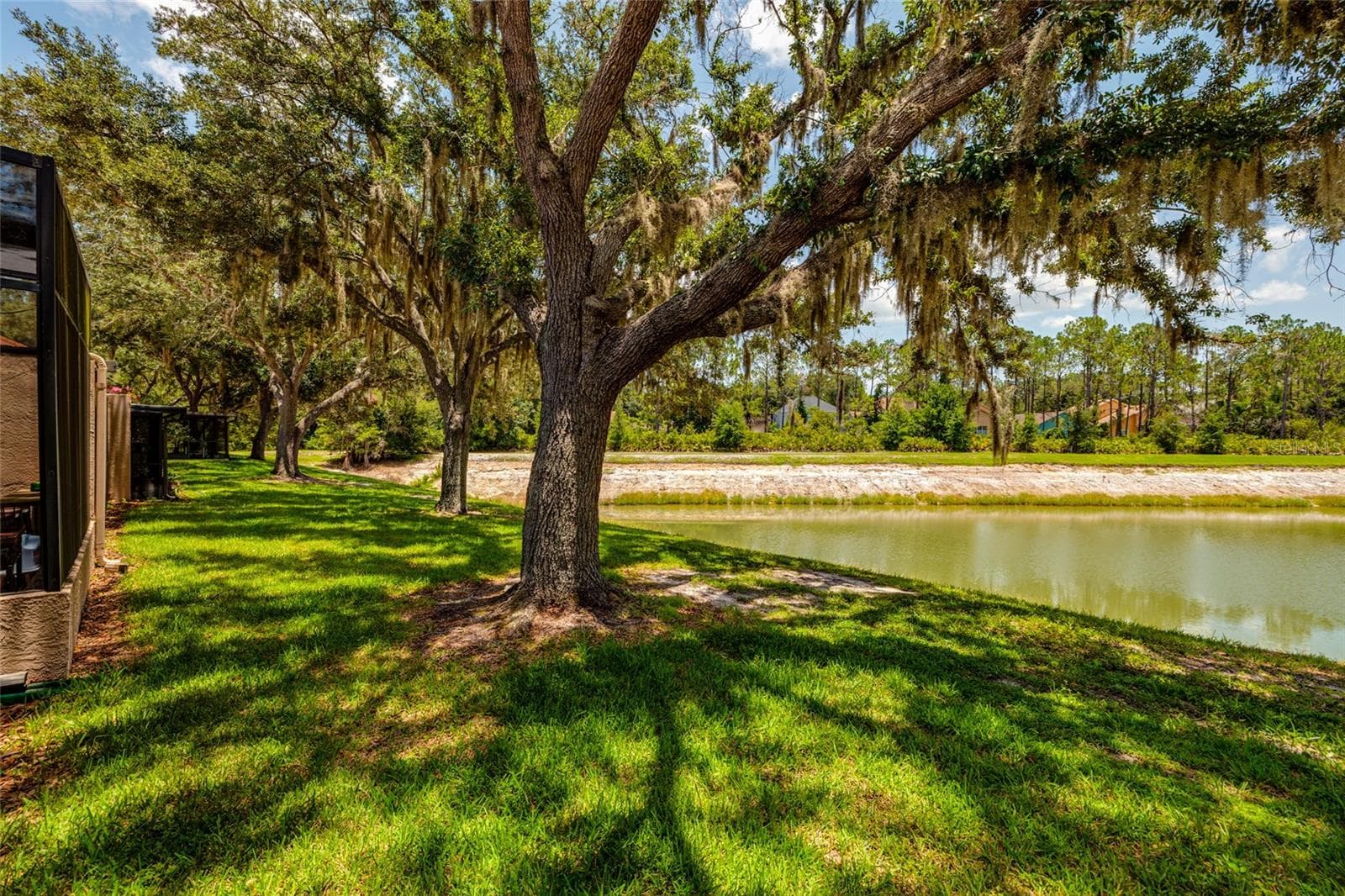 lake and yard view behind unit - 17557 FAIRMEADOW DR, TAMPA