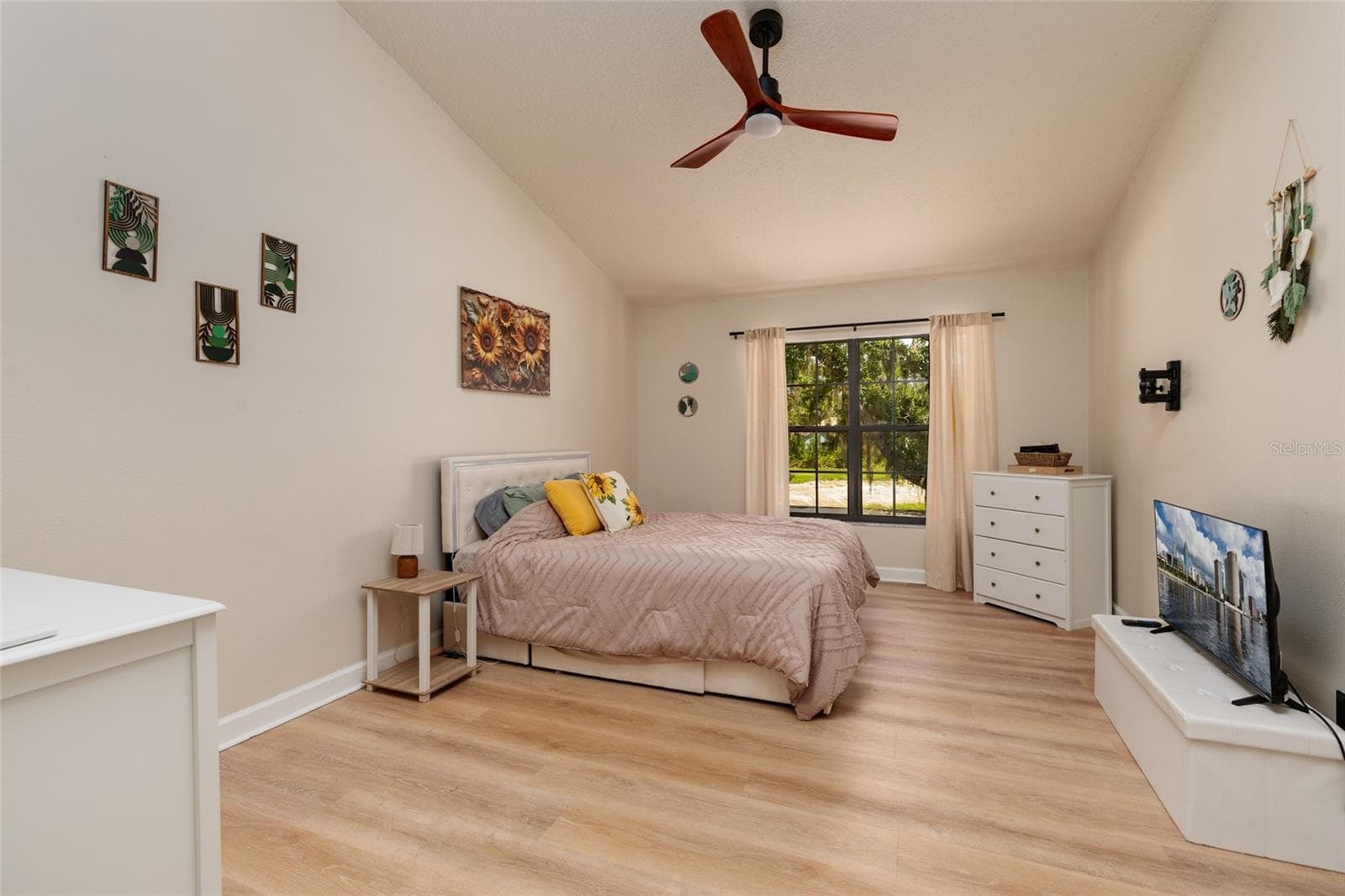 master bedroom with view of backyard tree and lake - 17557 FAIRMEADOW DR, TAMPA