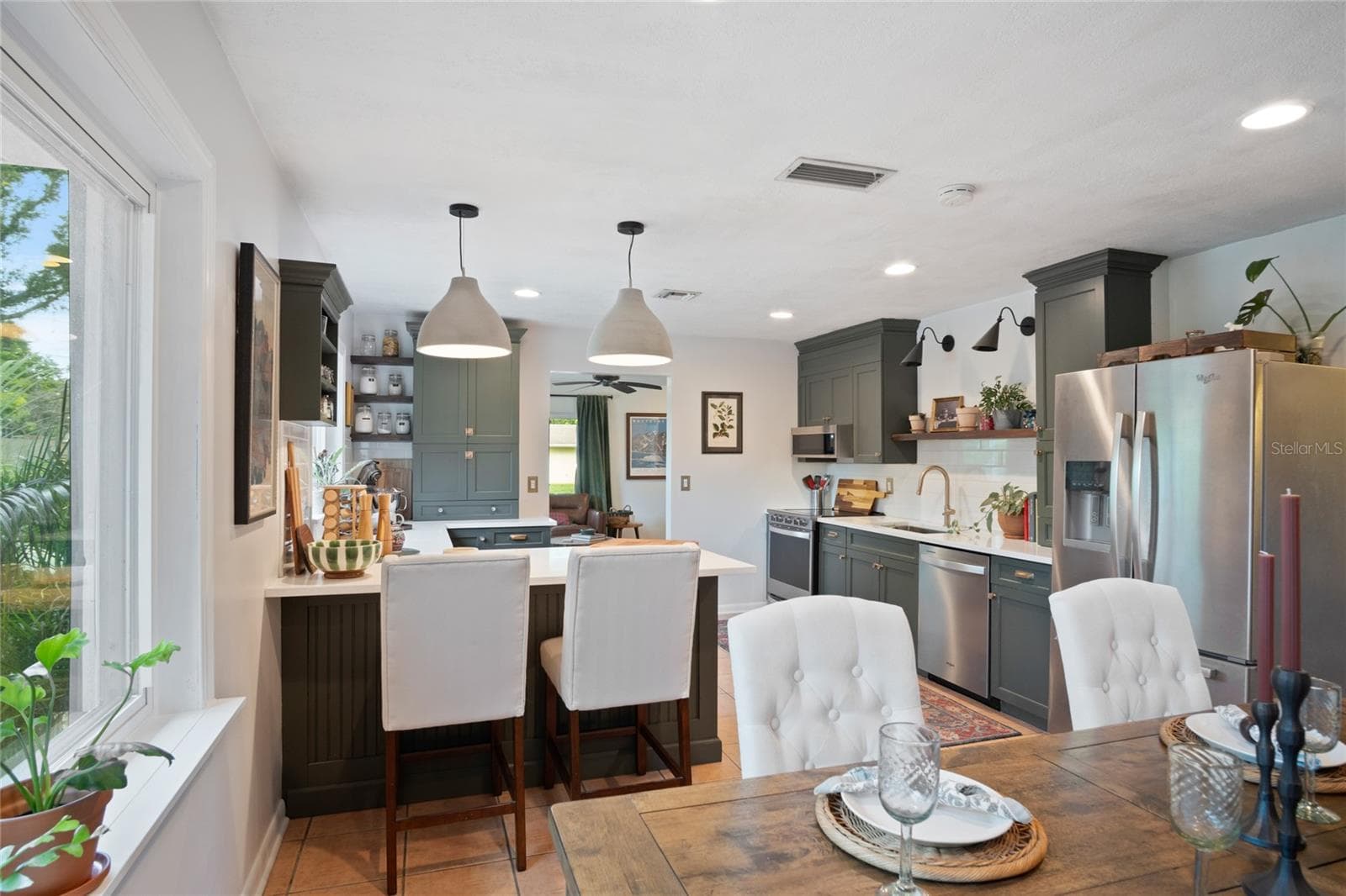 You'll notice the room in the dining area and the breakfast bar for gathering the family or guests to have a wonderful meal. - 501 MERIDALE AVE, ORLANDO