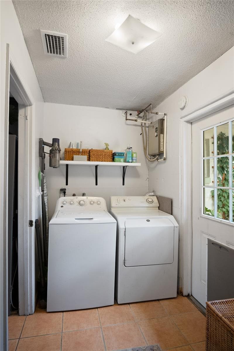 The laundry room leads to the backyard and is where the tankless water heater is located. - 501 MERIDALE AVE, ORLANDO