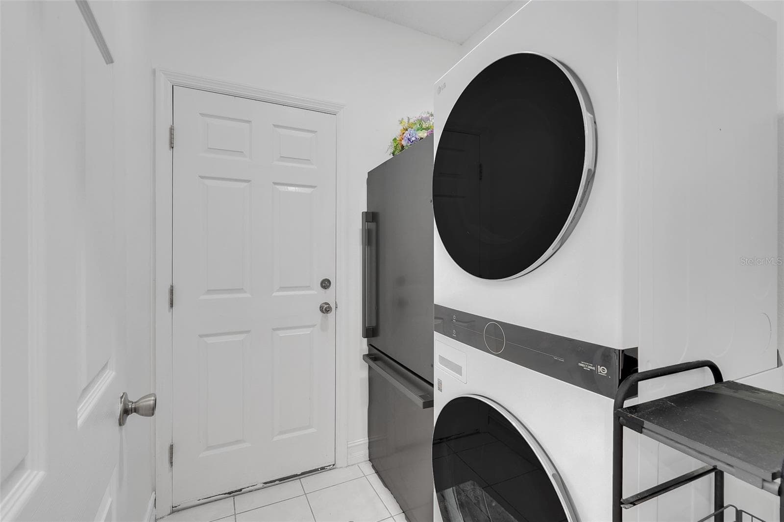 Inside laundry room with additional refrigerator that conveys - 16740 GLENBROOK BLVD, CLERMONT