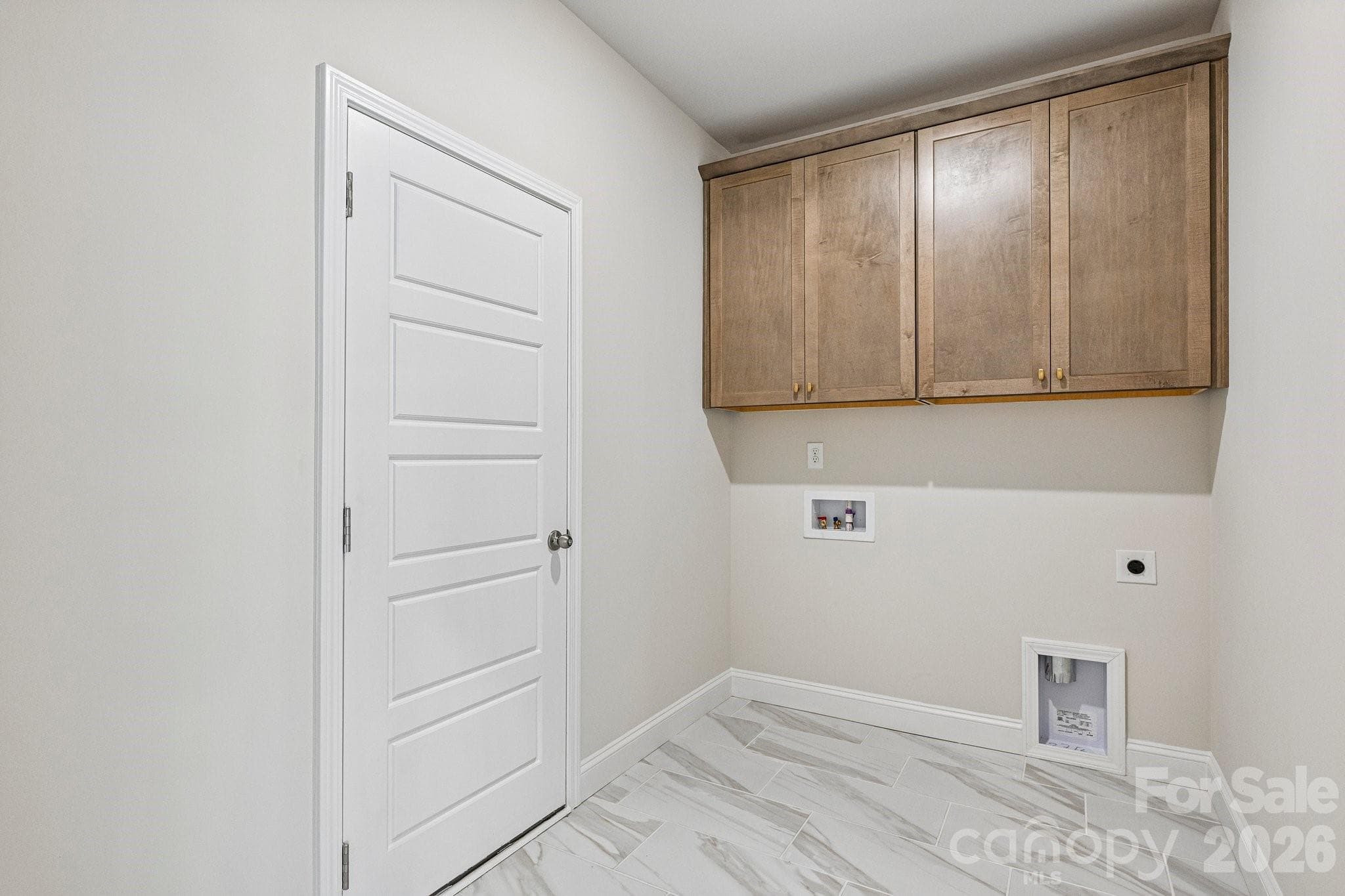 Main/upper level walk-in laundry room with upper cabinets - 605 Banter Lane, Gastonia