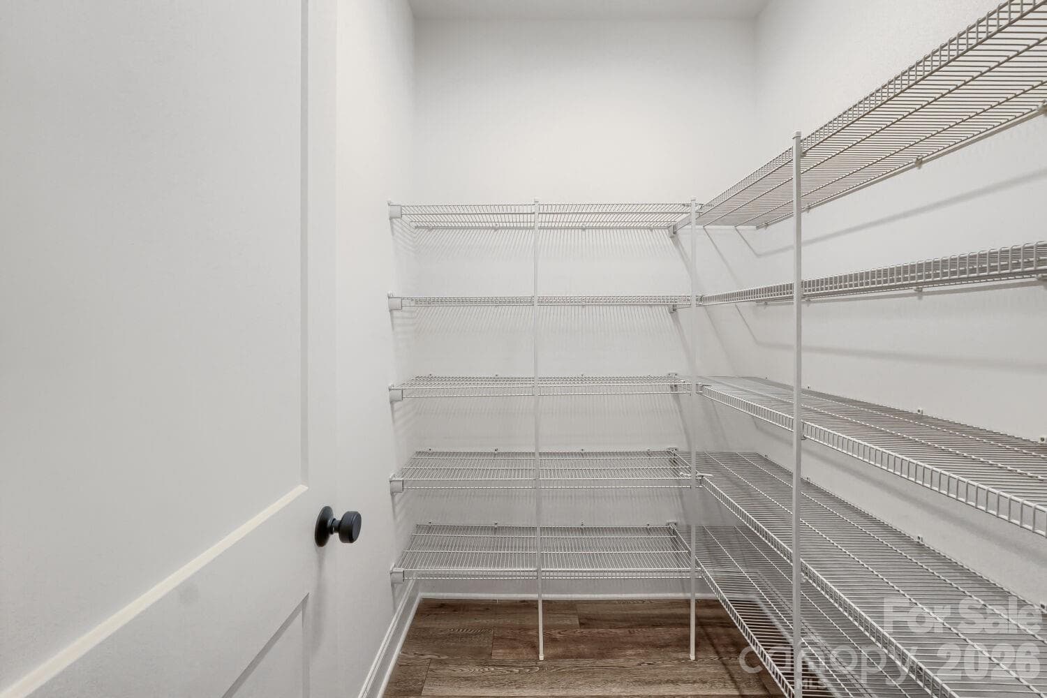 An oversized walk-in pantry or storage closet lined with abundant wire shelving. There's room for groceries, small appliances, and everything in between. - 2358 Fay Jones Road, Denver