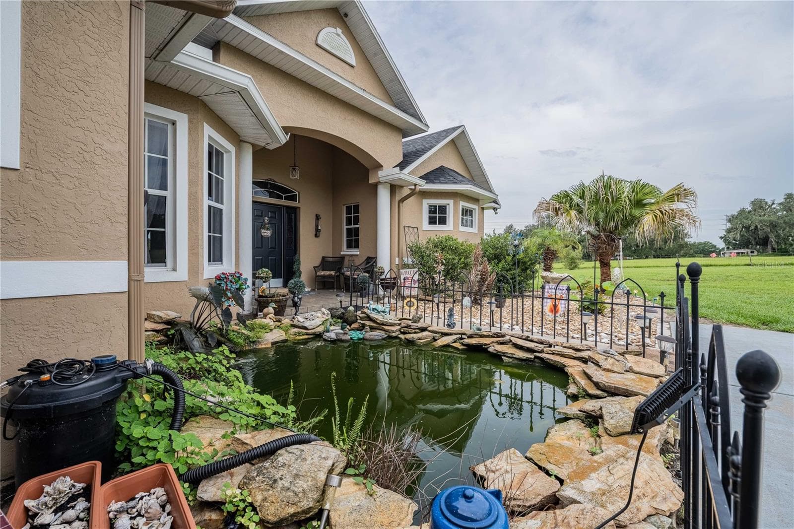 Front entry with Koi Pond and mature Koi fish - 4280 TURNER RD, MULBERRY