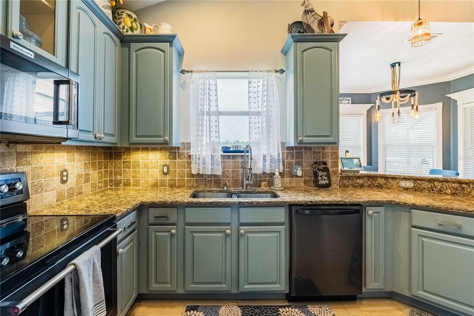 Kitchen with Granite countertops and tile backsplash overlooking the backyard - 4280 TURNER RD, MULBERRY