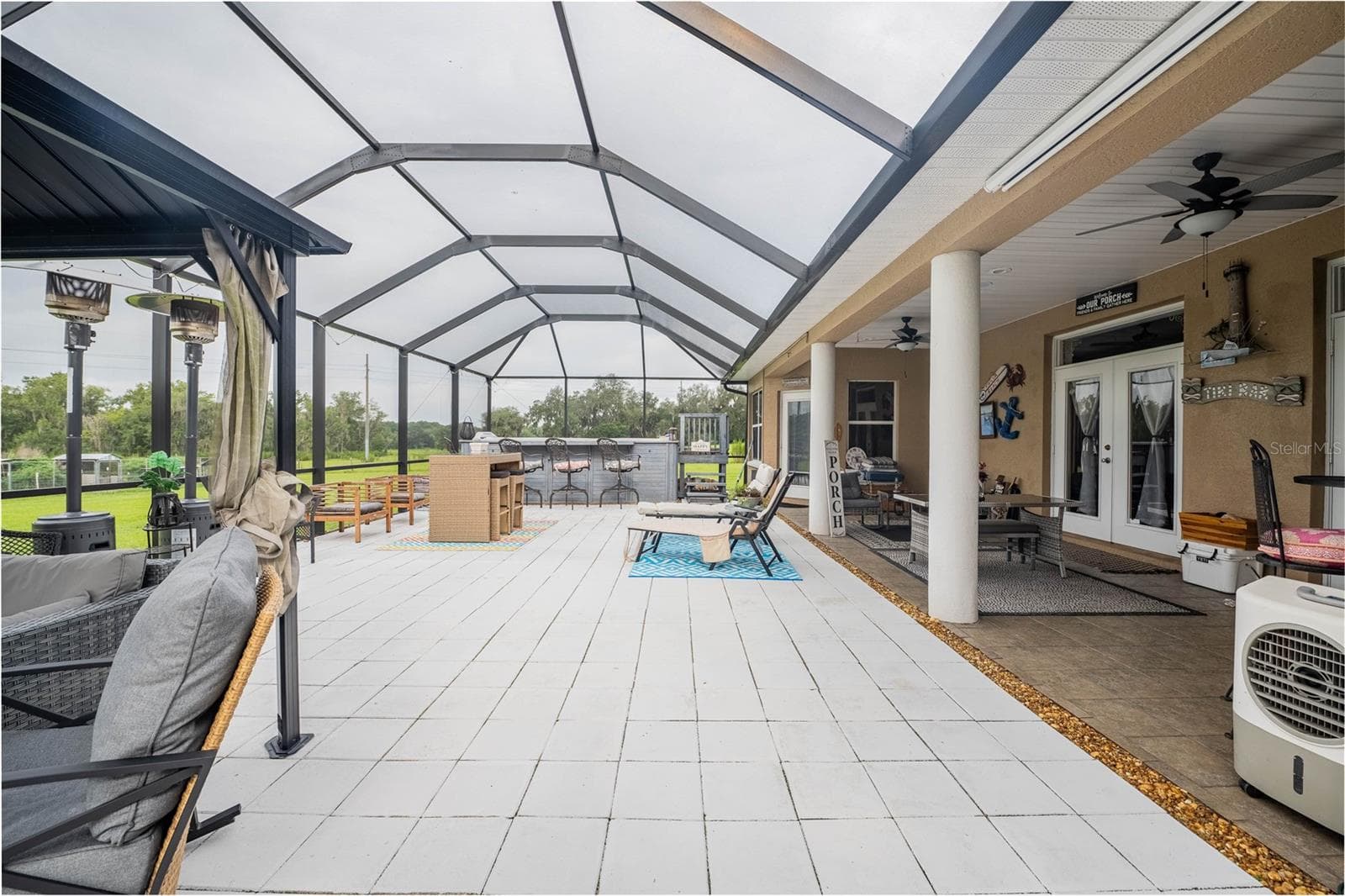 Spacious Lanai with covered seating, a swim spa, access to the 3rd full bath - 4280 TURNER RD, MULBERRY