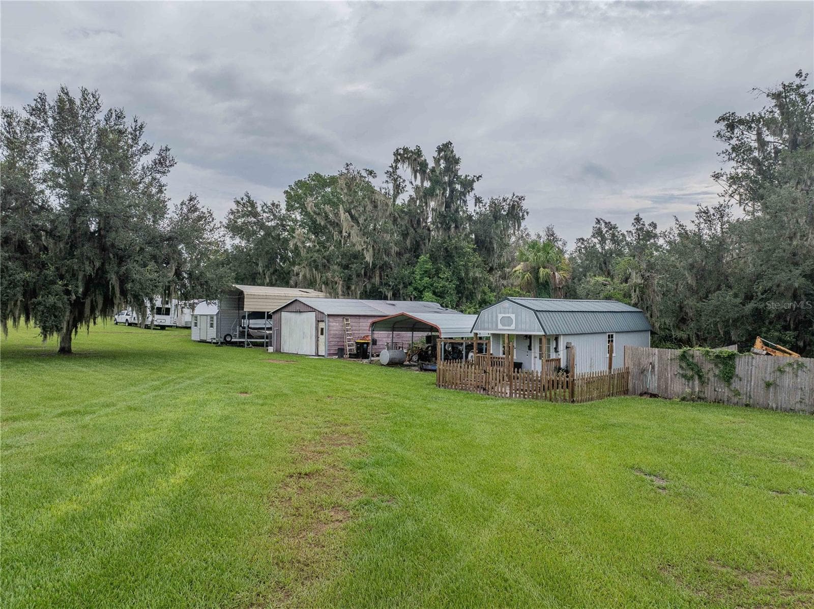 Tiny house with porch, 2 car carport, workshop, RV carport, shed - 4280 TURNER RD, MULBERRY