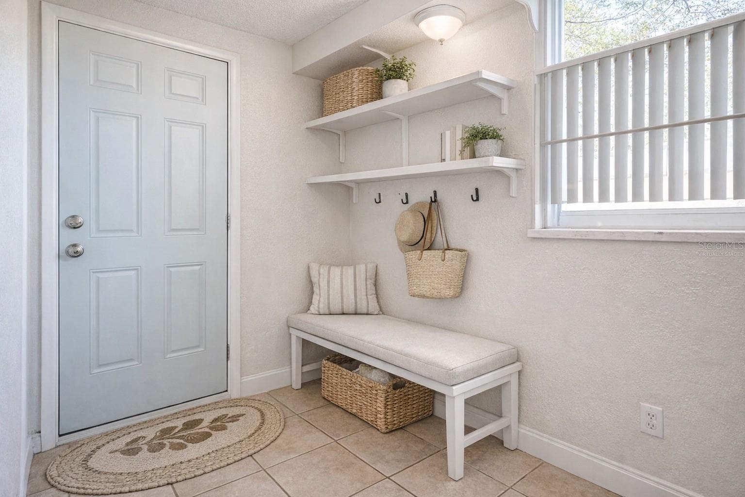 virtually staged mudroom leading to the backyard and paver patio - 5008 27TH AVE W, BRADENTON