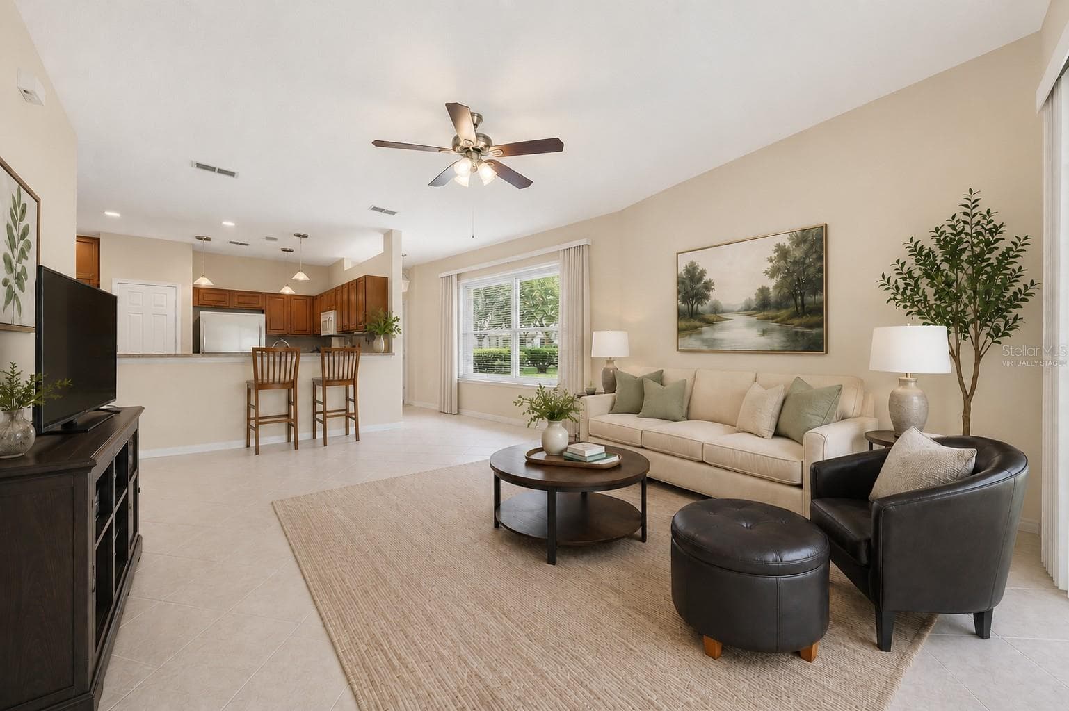 Living room virtually staged with view to kitchen - 9076 SAINT ANDREWS WAY, MOUNT DORA