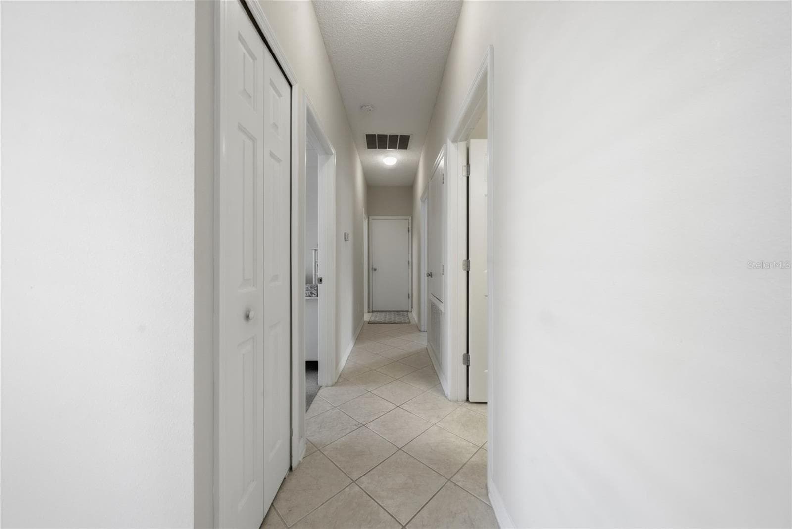 Hallway to guest bedrooms, laundry room and garage - 9076 SAINT ANDREWS WAY, MOUNT DORA