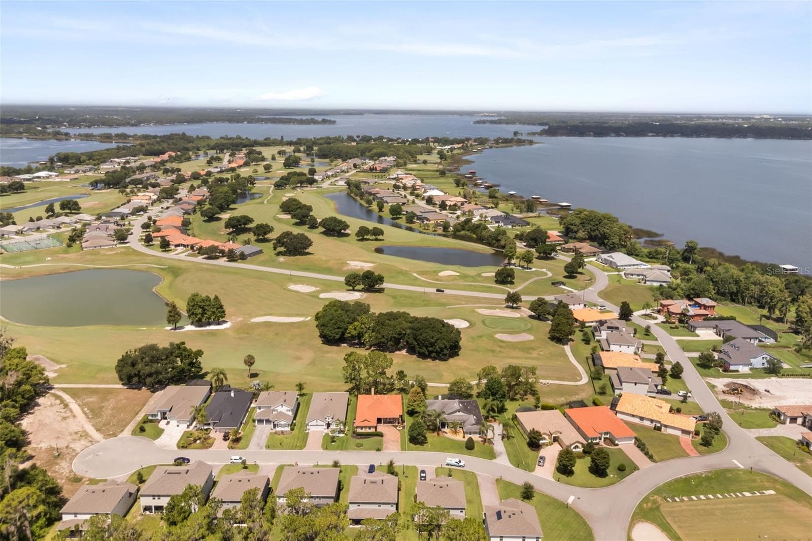 Aerial showing Deer Island: bottom right Driving Range, right Lake Dora, Top left causeway between Lake Dora & Lake Beauclair - 29925 CYPRESS POINTE, TAVARES