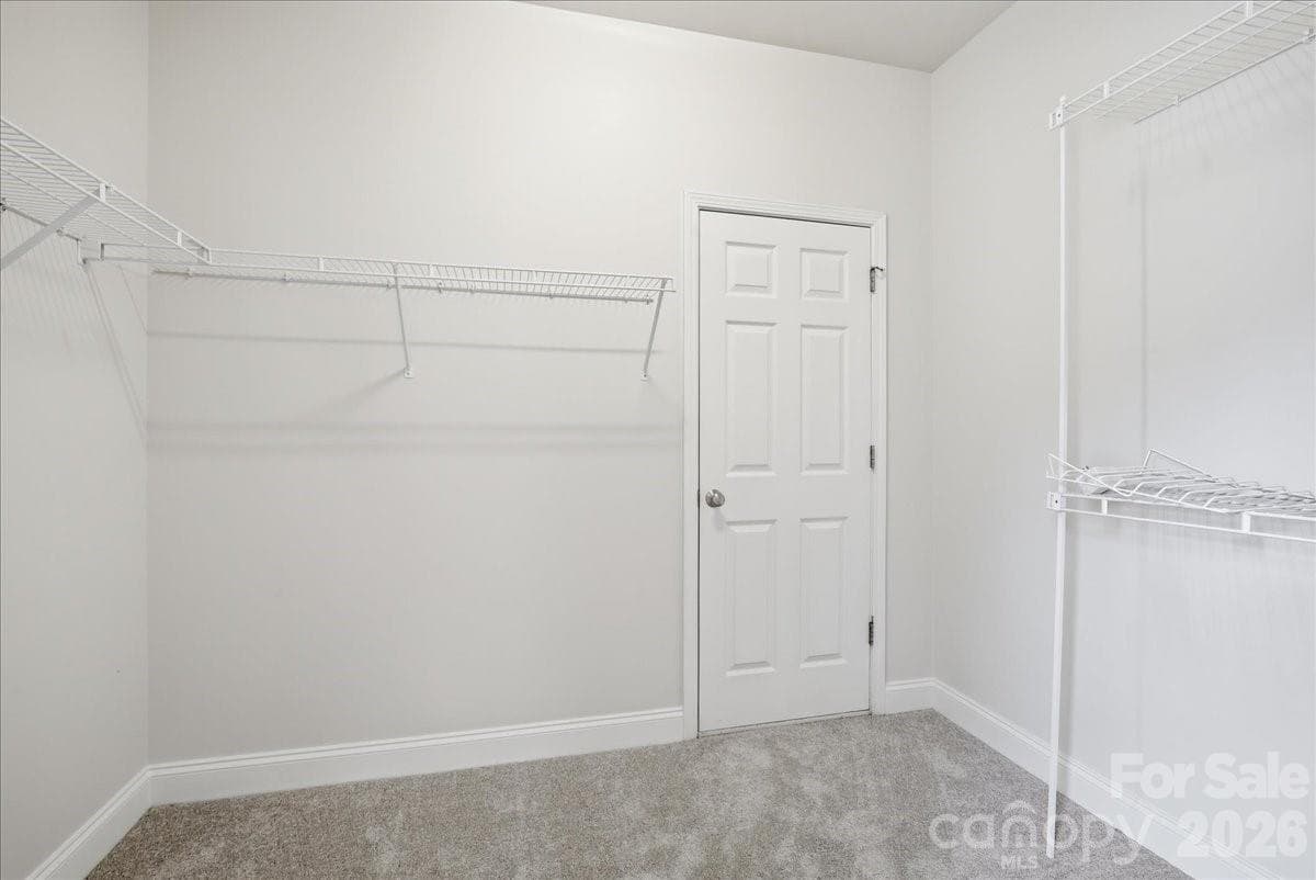 Walk-in closet. Door leads to climate controlled storage/flex space. Can fully finish to expand closet, workout room, office, craft room, etc. - 6055 Latta Springs Circle, Huntersville