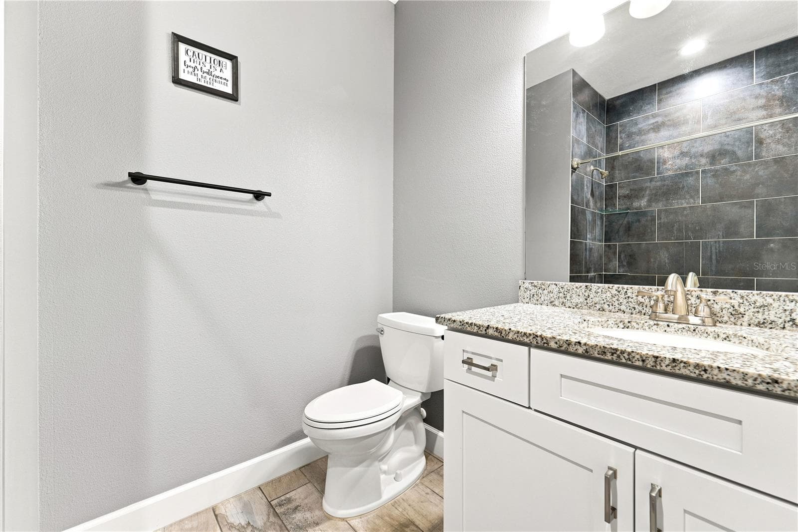 Guest Bathroom- Mirror reflecting shower wall adjacent to the vanity. - 125 LONGWOOD DR, OSTEEN