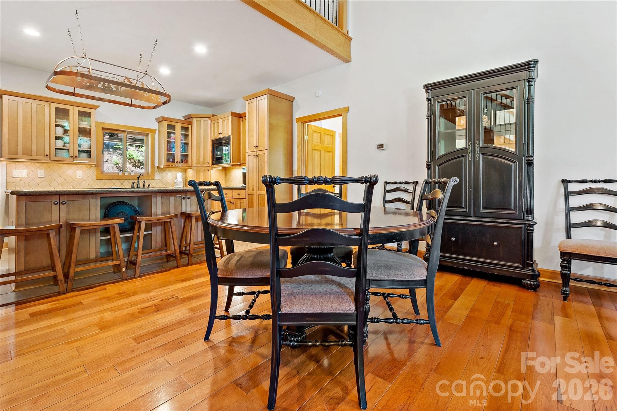 Open dining area connecting the kitchen and living room, conveniently located near both main-level bedrooms. - 179 Rock Spring Road, Lake Lure