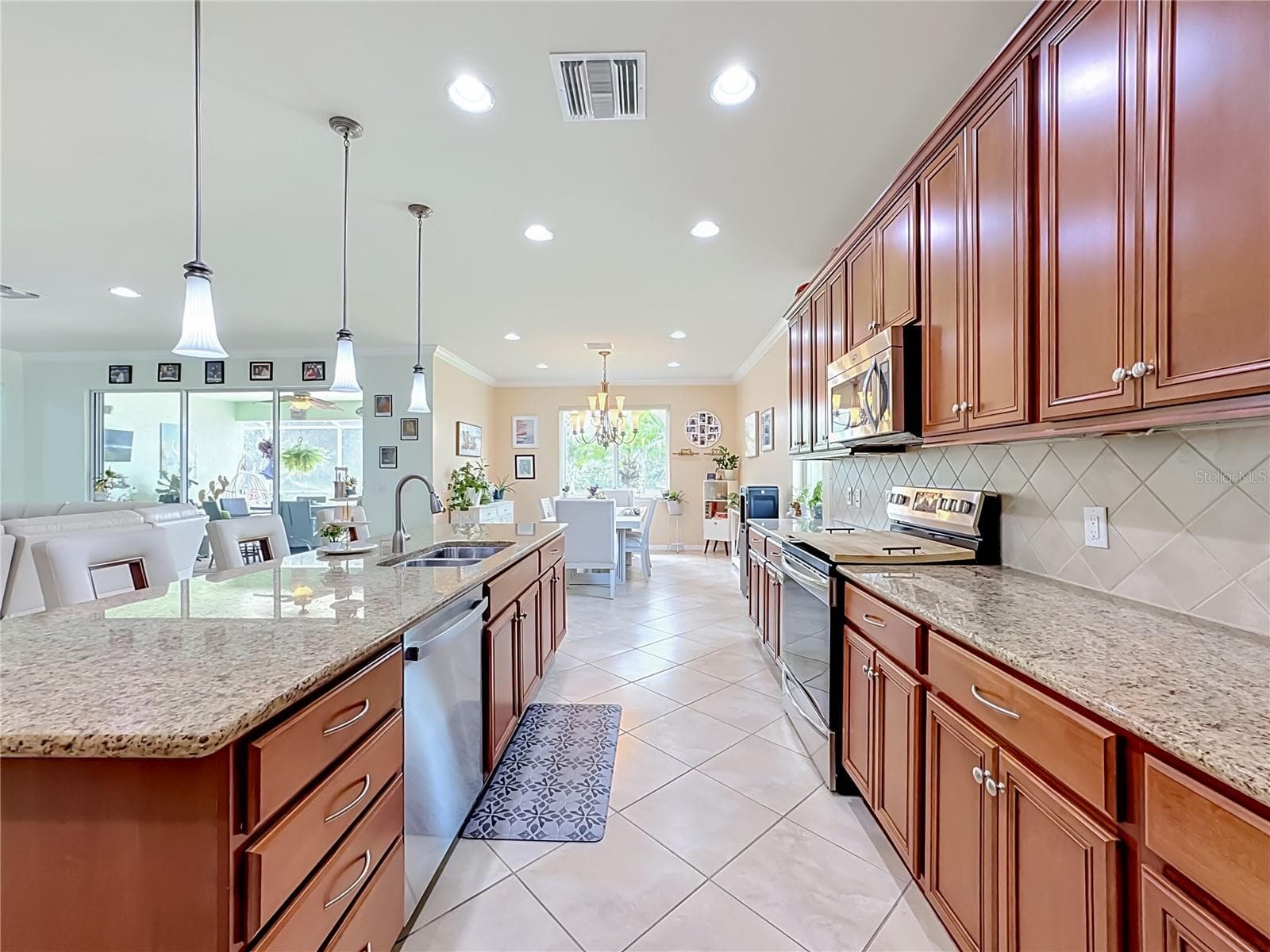 Chef’s Kitchen with High Ceilings and Pendant Lighting - 6149 ABACO DR, SARASOTA