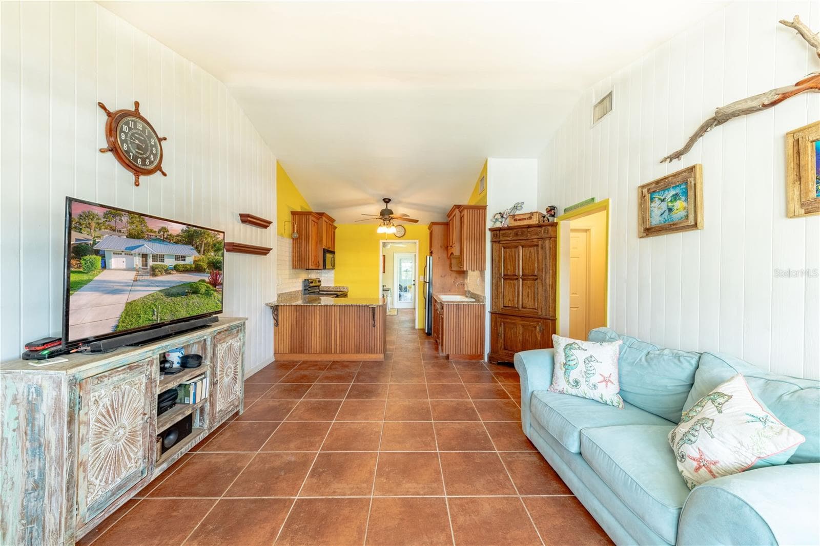 Living room/kitchen features High Ceilings and modern coastal decoreincluding shiplap and beautiful built in wooden pantry. - 316 ALBA ST E, VENICE