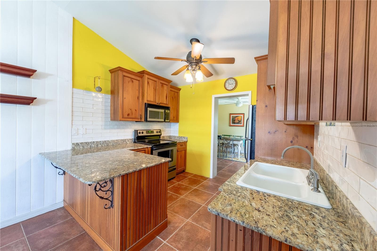 Kitchen features custom tile backsplash, ture cast iron white sink and granite counters. - 316 ALBA ST E, VENICE