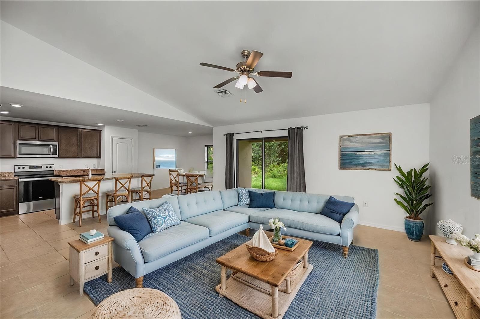 Virtually Staged Open Concept Living Room with Kitchen and Dining Nearby - 2555 ATWATER DR, NORTH PORT