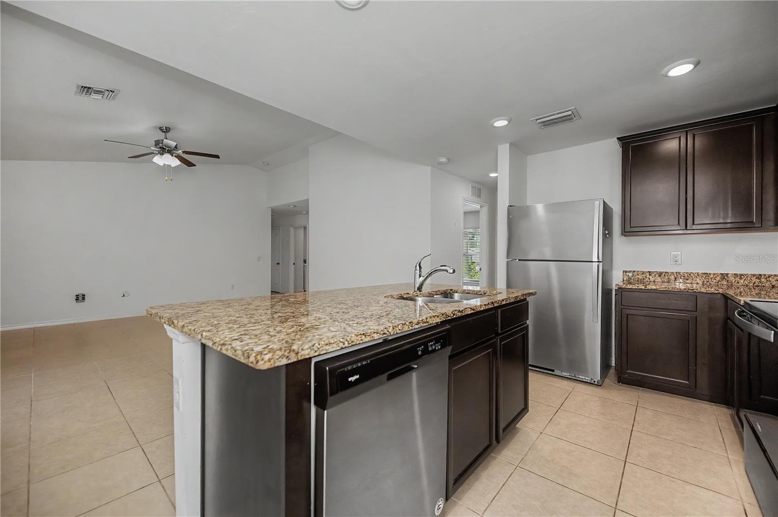 Granite Breakfast Bar with Dark Cabinetry - 2555 ATWATER DR, NORTH PORT