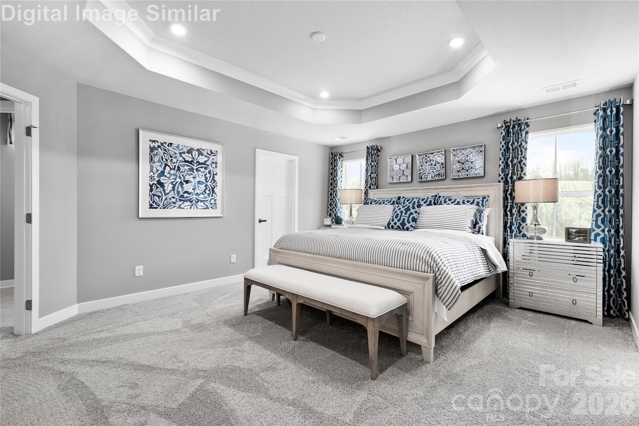 Dreamy owner’s suite with expansive windows that fill the space with natural light. Optional tray ceiling adds elegance. Easily fits a king-size bed with room to spare—ready to be styled your way. - 11194 Emerson Landing Drive, Charlotte