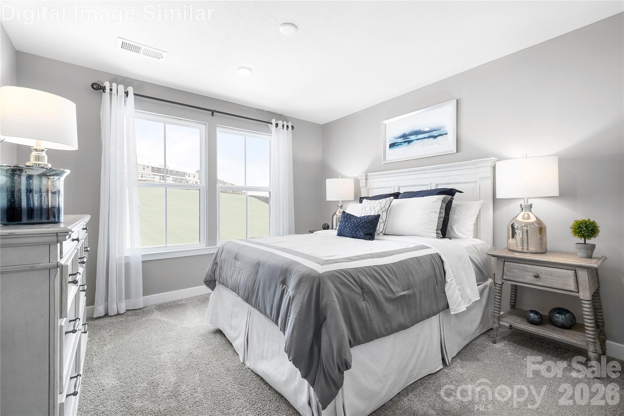 Comfortably sized guest bedroom with two large windows—bright, inviting, and ready to be styled to suit any taste. - 11194 Emerson Landing Drive, Charlotte