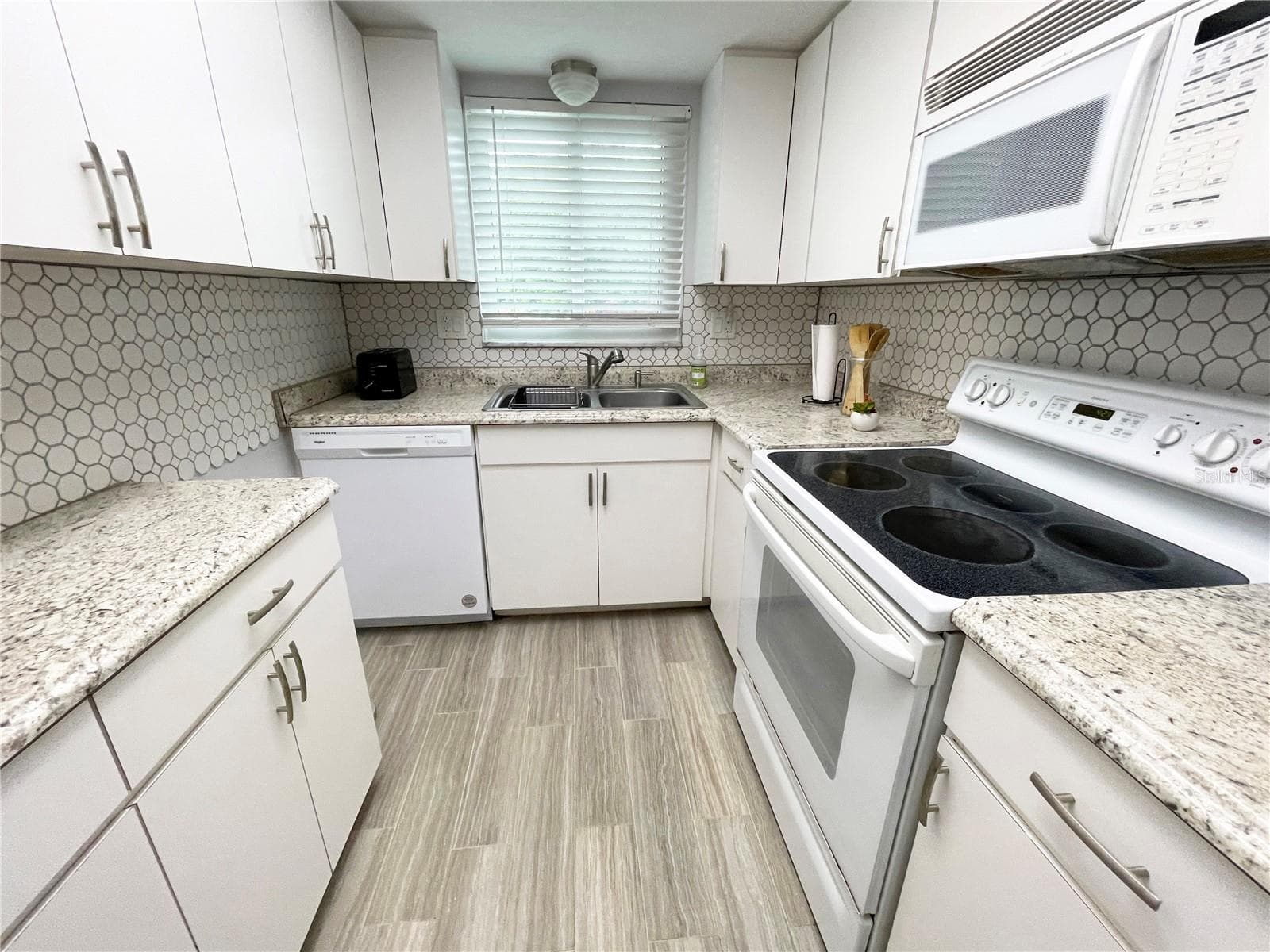 Updated kitchen with dishwasher, microwave, refrigerator and stove. - 5880 38TH AVE N #206, ST PETERSBURG