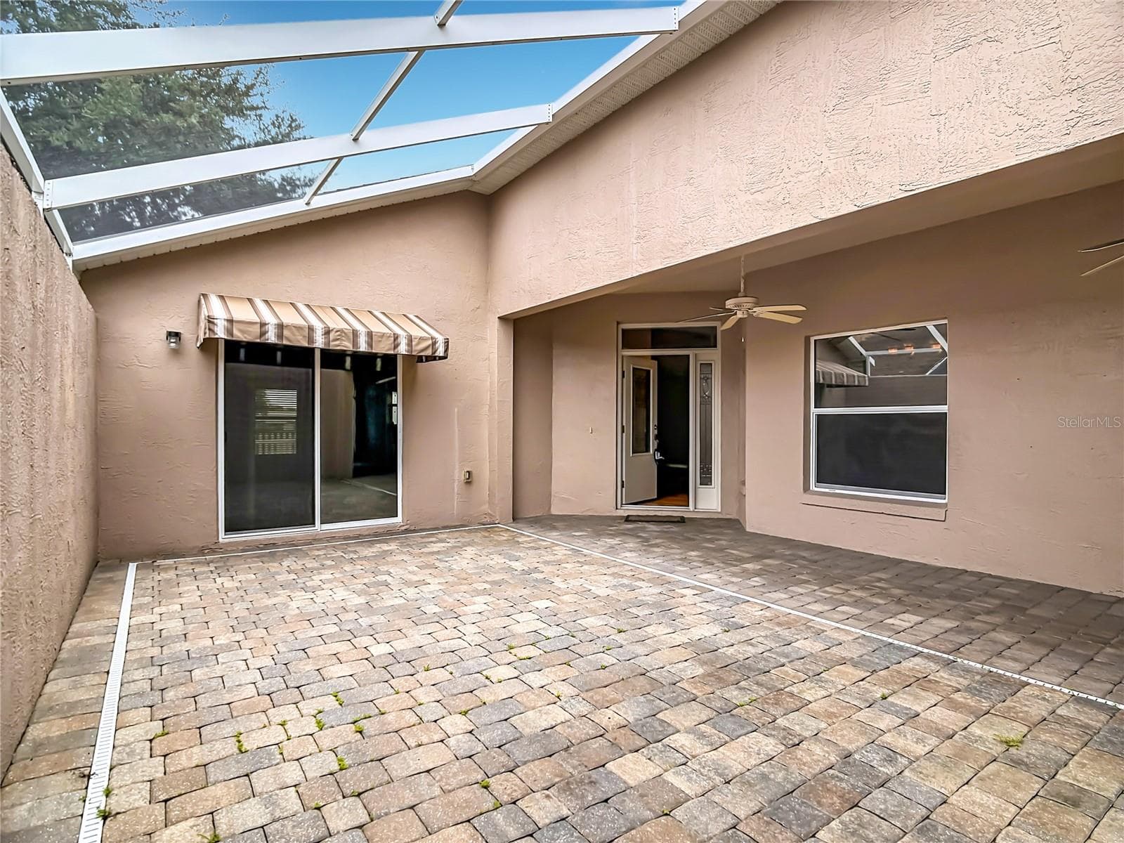 Main residence front entryway with beautiful courtyard as a backdrop - 4178 CANNES AVE, LAKE WALES