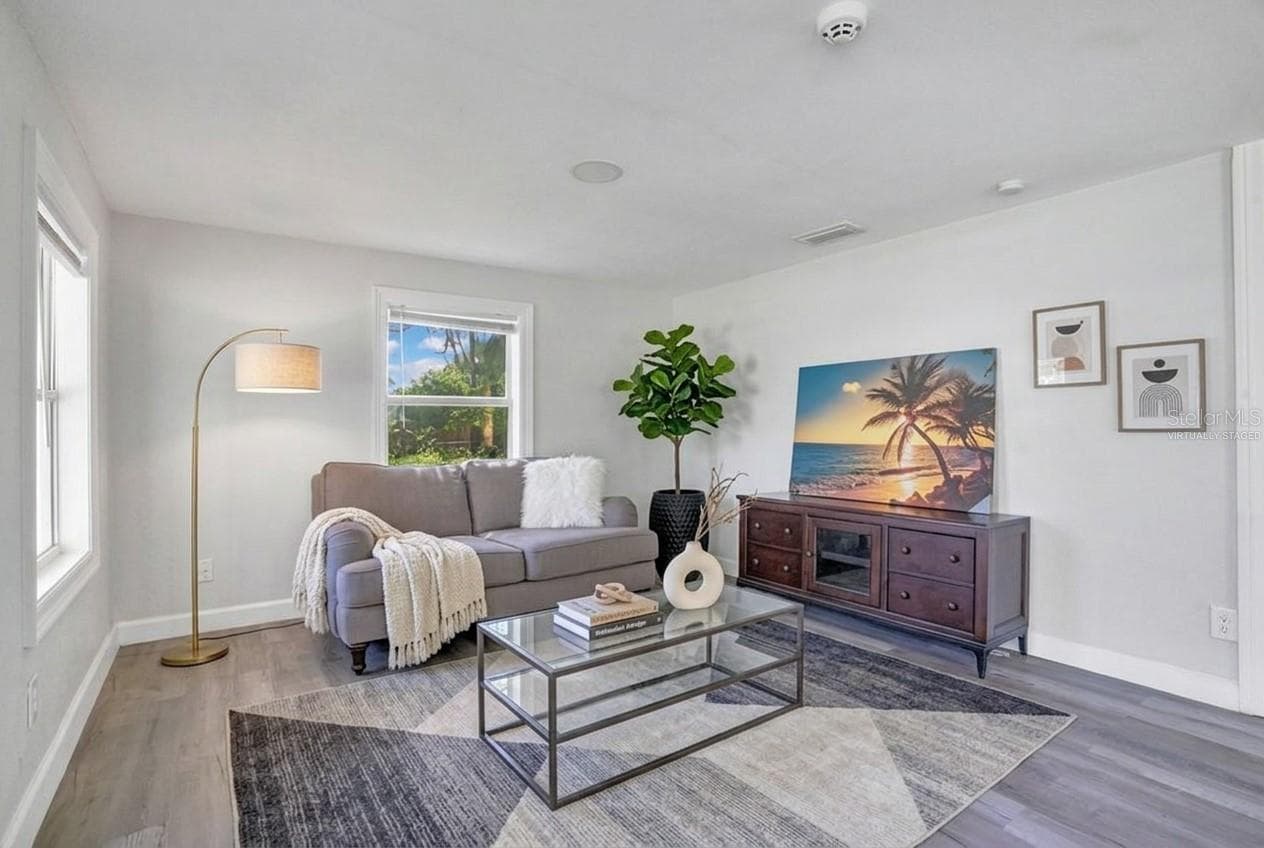 Inside, WOOD LAMINATE FLOORING flows throughout the home, while large windows fill the open living and dining areas with beautiful natural light. Virtually Staged. - 2012 E HARDING ST, ORLANDO