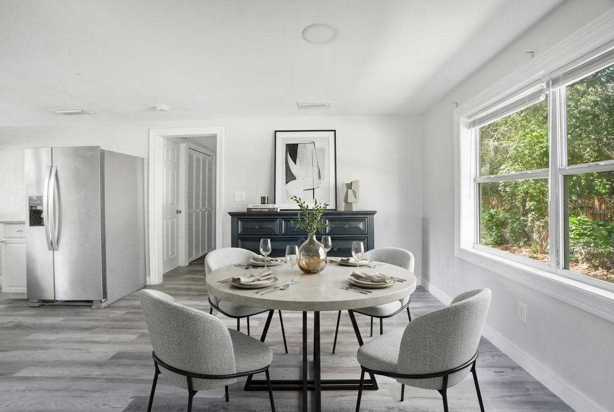 Light filled dining area has a seamless flow into the kitchen and living area. Virtually Staged. - 2012 E HARDING ST, ORLANDO