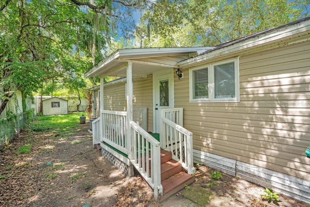 Second side entrance and covered porch. - 2012 E HARDING ST, ORLANDO