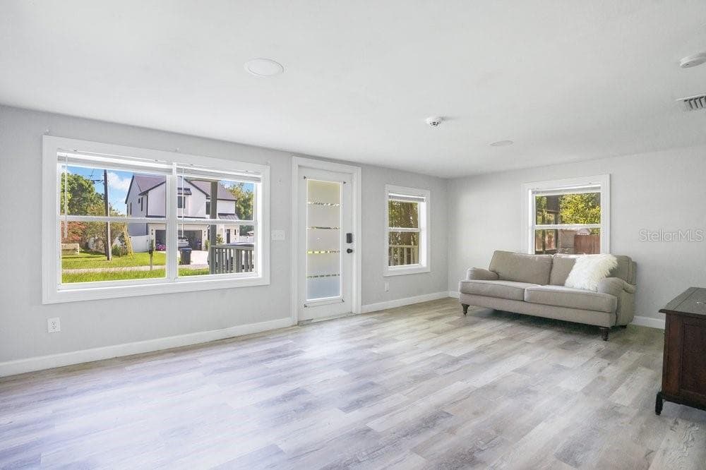Large windows deliver a light filled living space. - 2012 E HARDING ST, ORLANDO