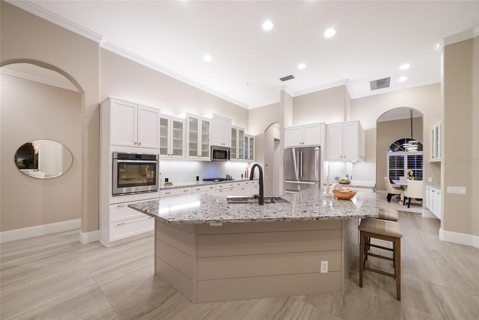 Counter height stone island centers the updated Lakewood Ranch kitchen - 8122 LONE TREE GLN, LAKEWOOD RANCH