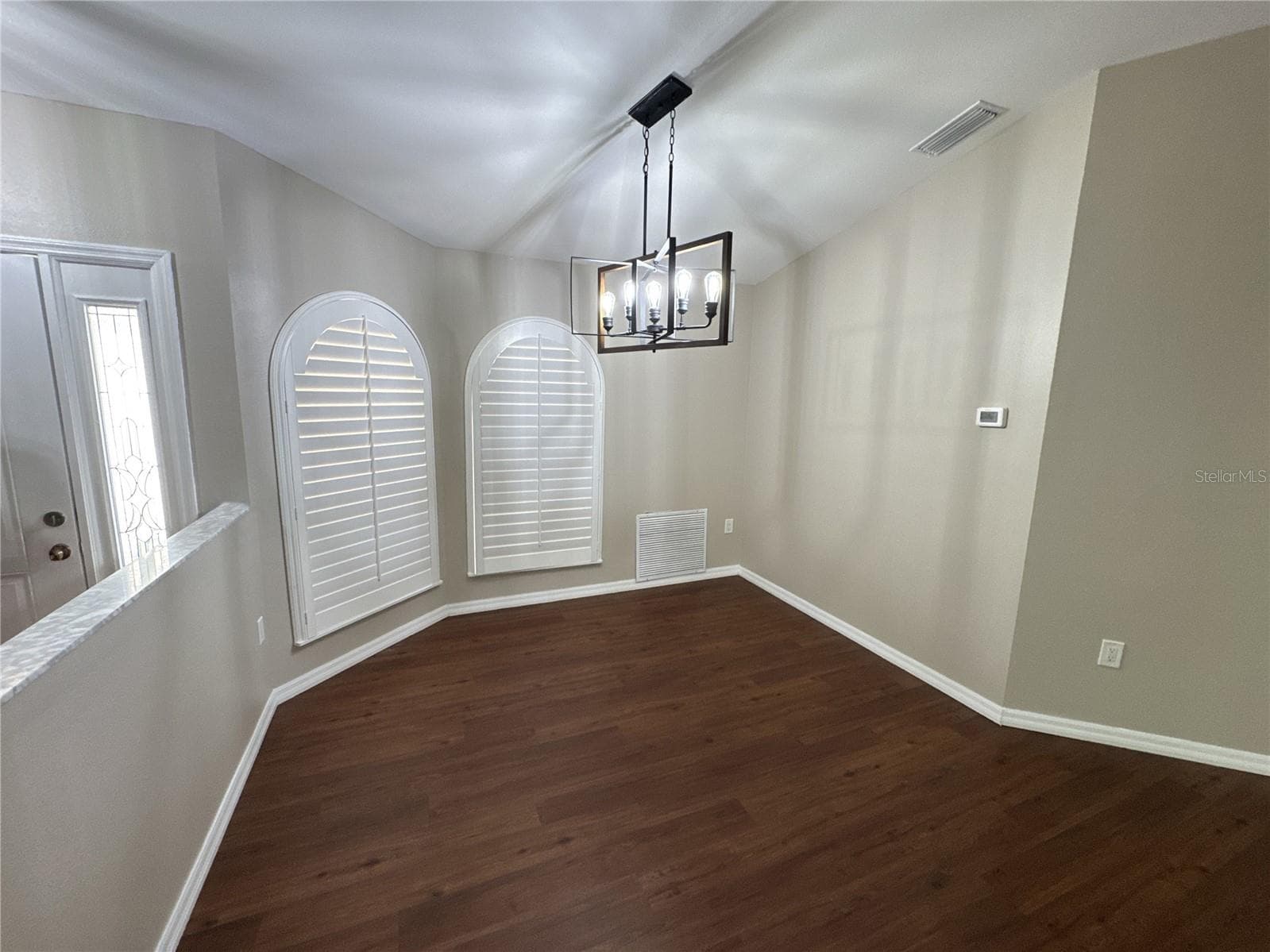 dining room with plantation shutters on both curved windows - 3174 57TH AVENUE CIR E, BRADENTON