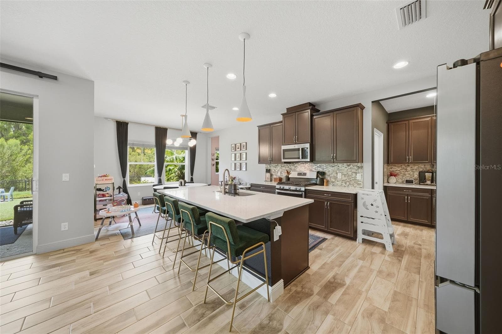 The spacious kitchen is designed for both everyday living and entertaining, featuring abundant cabinetry and counter space, a sunny breakfast nook, and a convenient butler's pantry for added storage and effortless serving - 4801 BALLANTRAE BLVD, LAND O LAKES