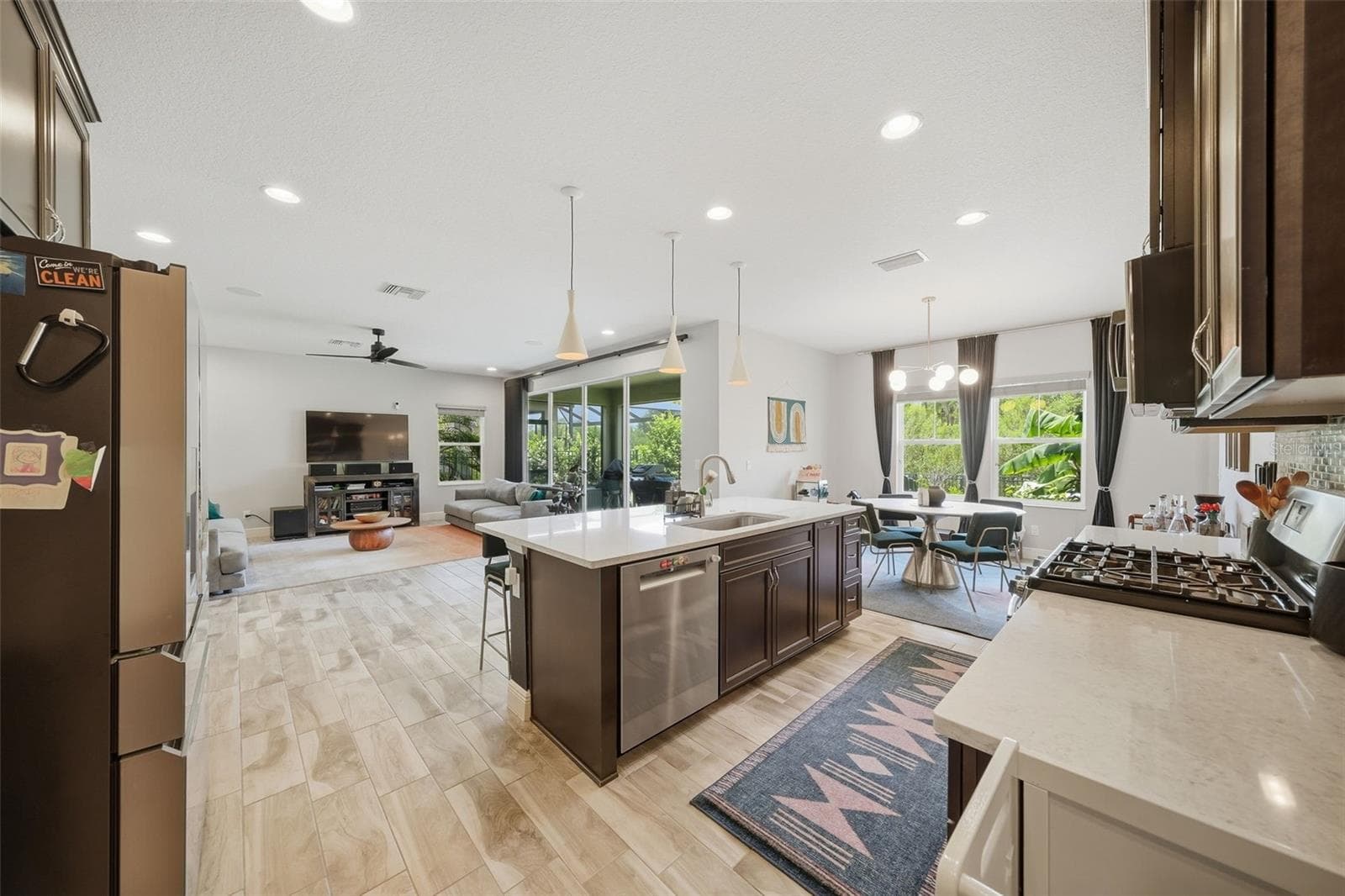 Perfect for entertaining, the kitchen opens effortlessly to the breakfast nook and spacious living room, allowing everyone to stay connected while sliding glass doors provide beautiful views and easy access to the outdoor space. - 4801 BALLANTRAE BLVD, LAND O LAKES