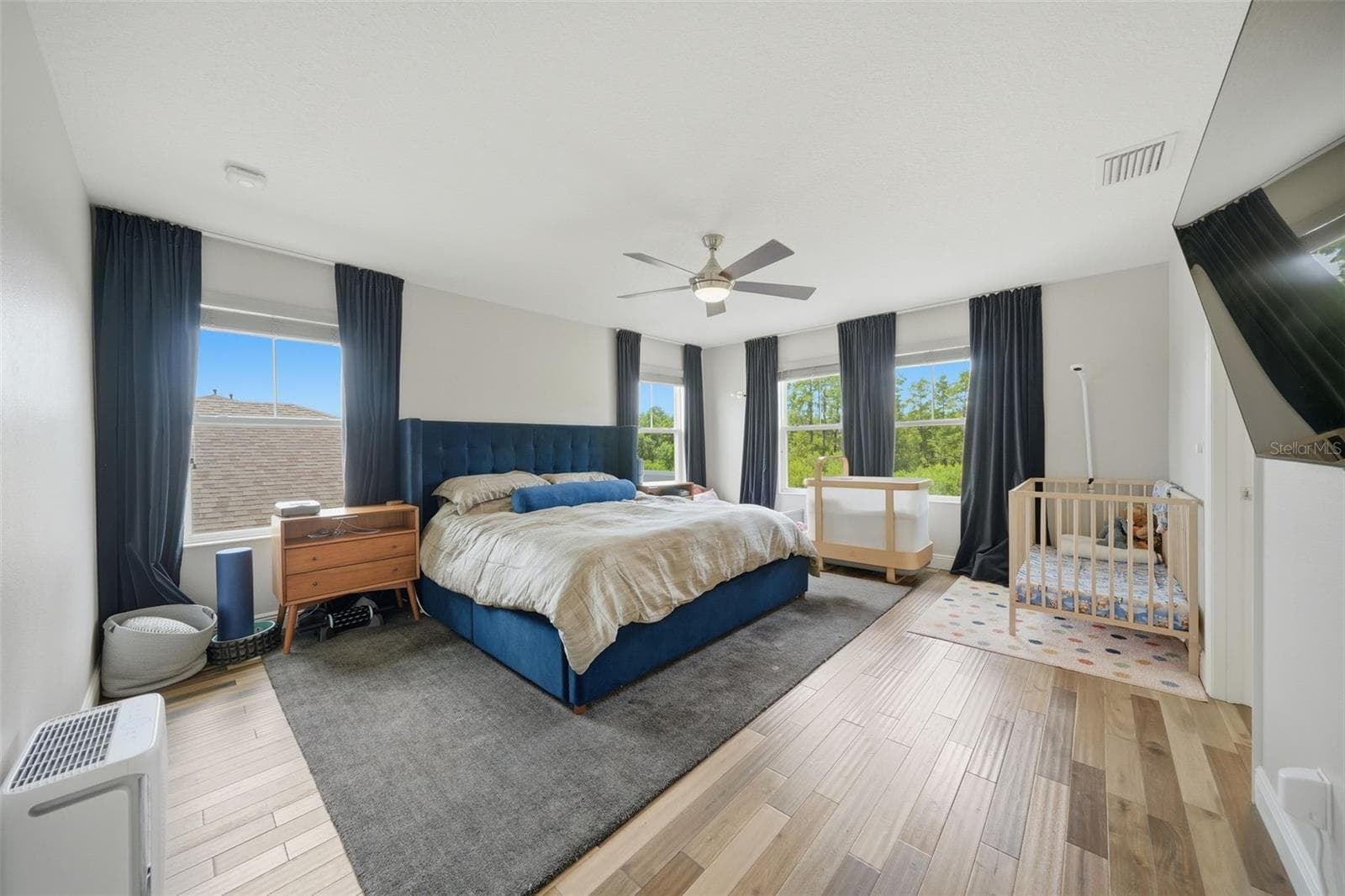 The oversized primary suite is a true retreat, featuring ample space for a sitting area and oversized furnishings while providing a peaceful escape at the end of the day. - 4801 BALLANTRAE BLVD, LAND O LAKES