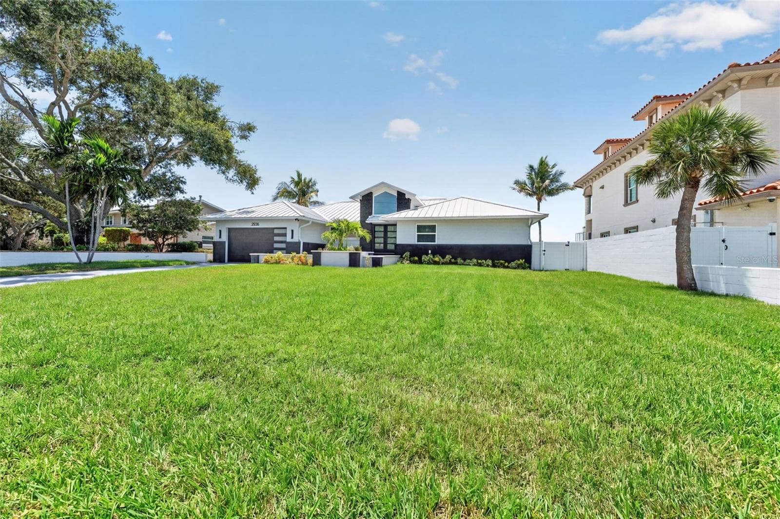 Sleek standing seam metal roof adds modern style and long-lasting durability. - 2936 68TH AVE S, ST PETERSBURG